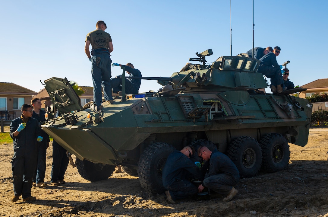 U.S. Marines with Light Armored Reconnaissance Training Company, Advanced Infantry Training Battalion, School of Infantry - West, apply grease to a LAV-25 Light Armored Vehicle prior to LAR Marine Course 2-20’s LAV swim operations at the Del Mar boat basin on Marine Corps Base Camp Pendleton, California, Feb. 11, 2020. The mission of LARTC is to train entry-level light armored reconnaissance crewmen in the tactical employment of the LAV. (U.S. Marine Corps photo by Lance Cpl. Melissa I. Ugalde)