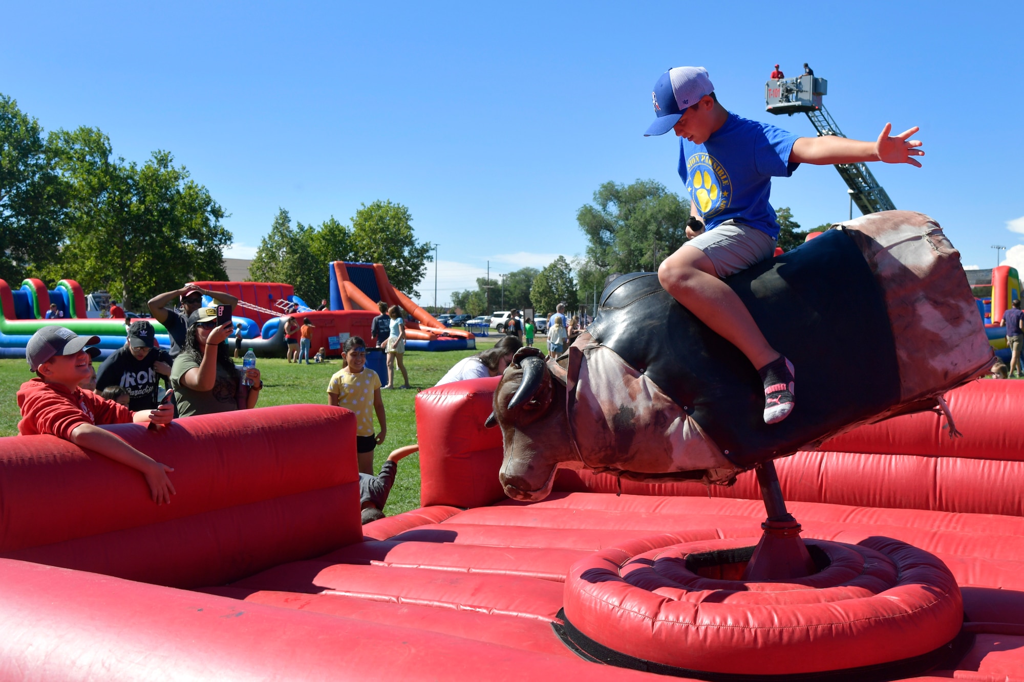 A child riding a mechanical bull.