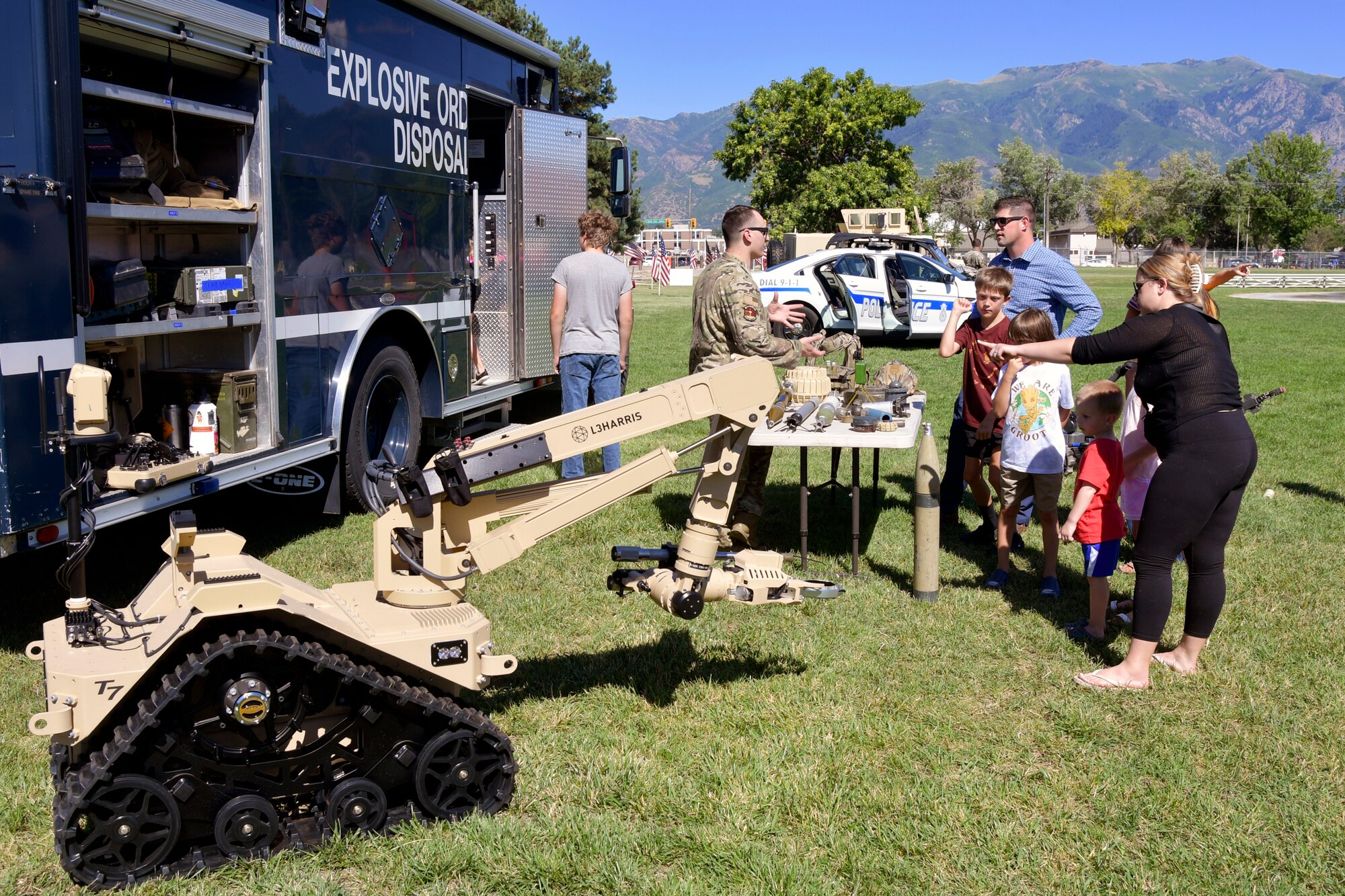 A military family visits the Explosive Ordnance Disposal equipment display.