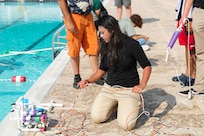 A student with the Naval Surface Warfare Center Indian Head Division’s (NSWC IHD) Naval Energetics Technology Apprenticeship Program (NETAP) prepares their underwater remotely operated vehicle for her group’s scenario at Naval Support Facility Indian Head, July 28. NETAP provides students an opportunity to engage in a hands-on internship allowing them to develop their engineering skills. Over the course of the program, students learned and improved upon their tooling, soldering and programming skills by building miniature unmanned underwater vehicles