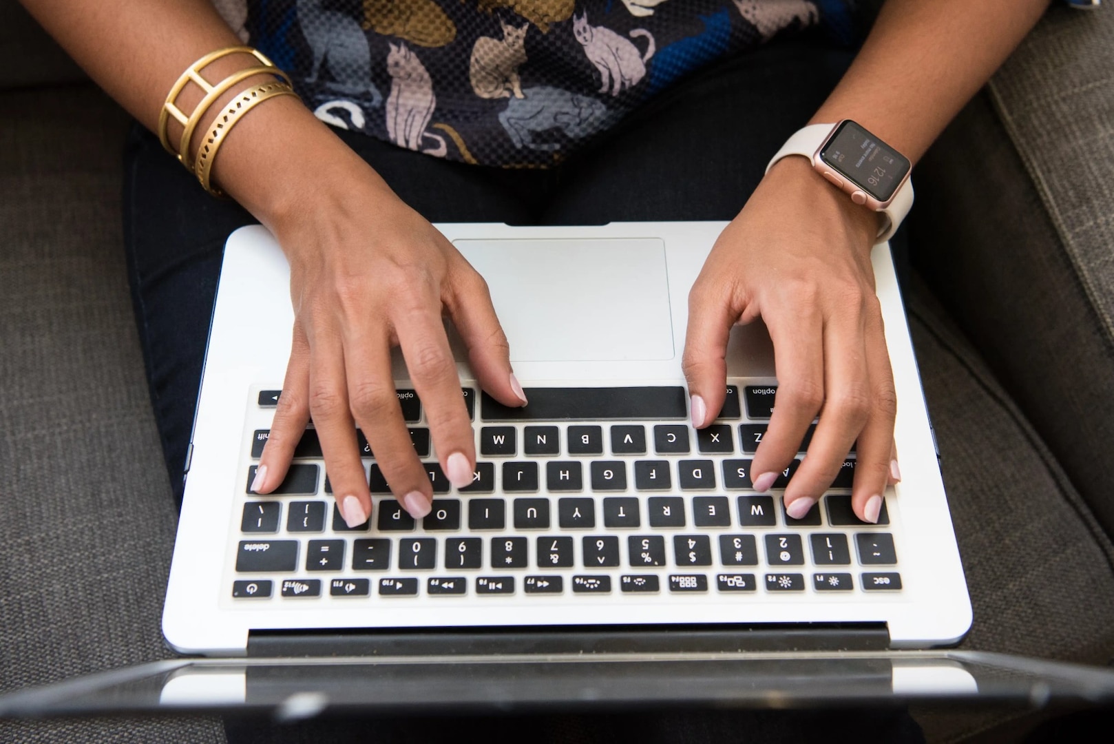 Closeup of a person's hands on a laptop keyboard