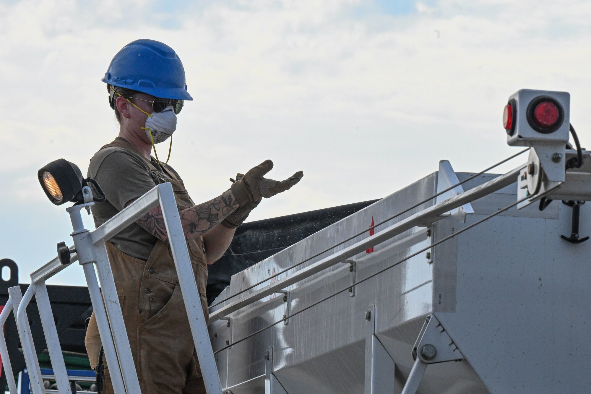 An Airmen puts on a glove.