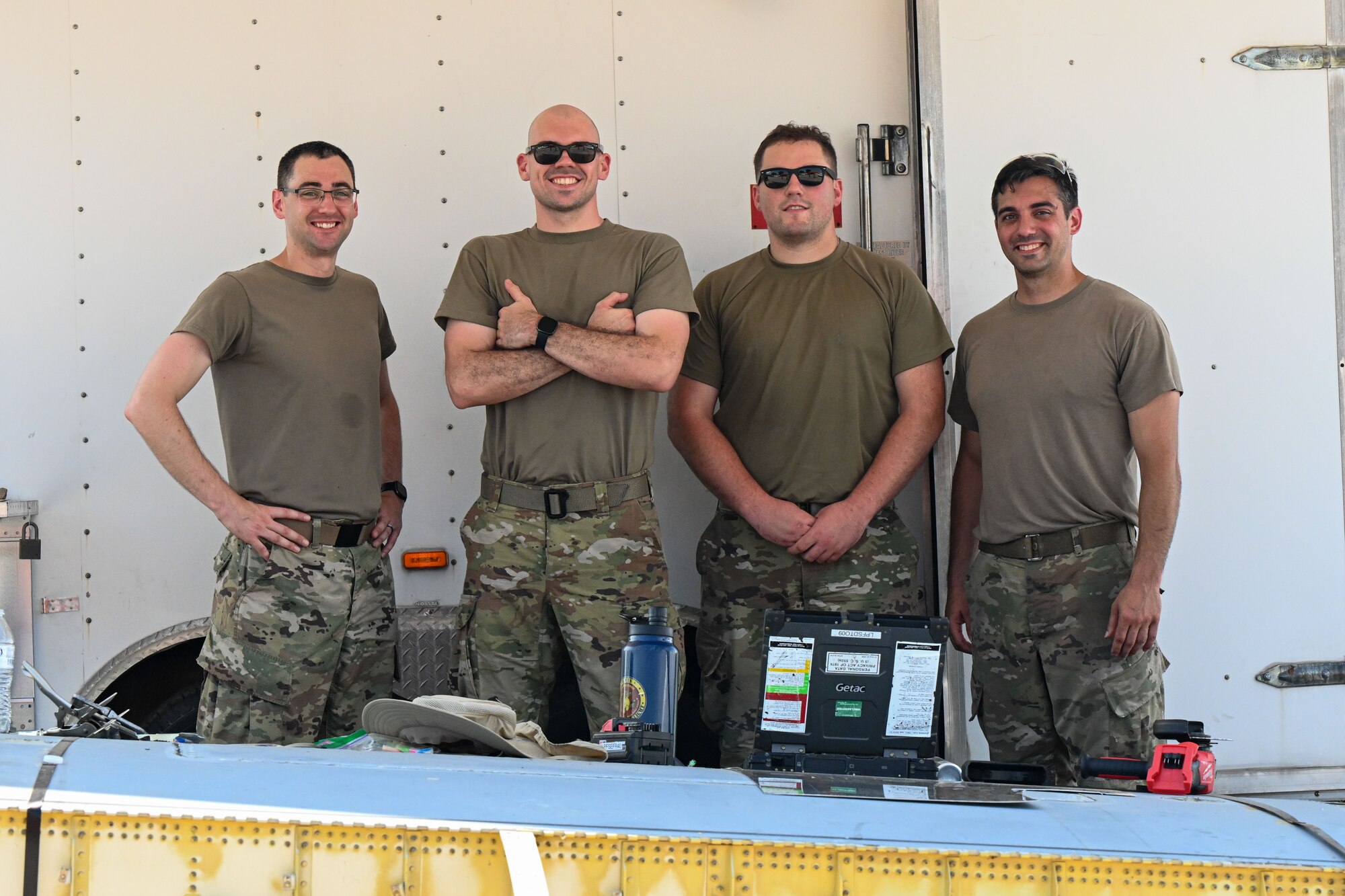 Airmen pose for a photo.