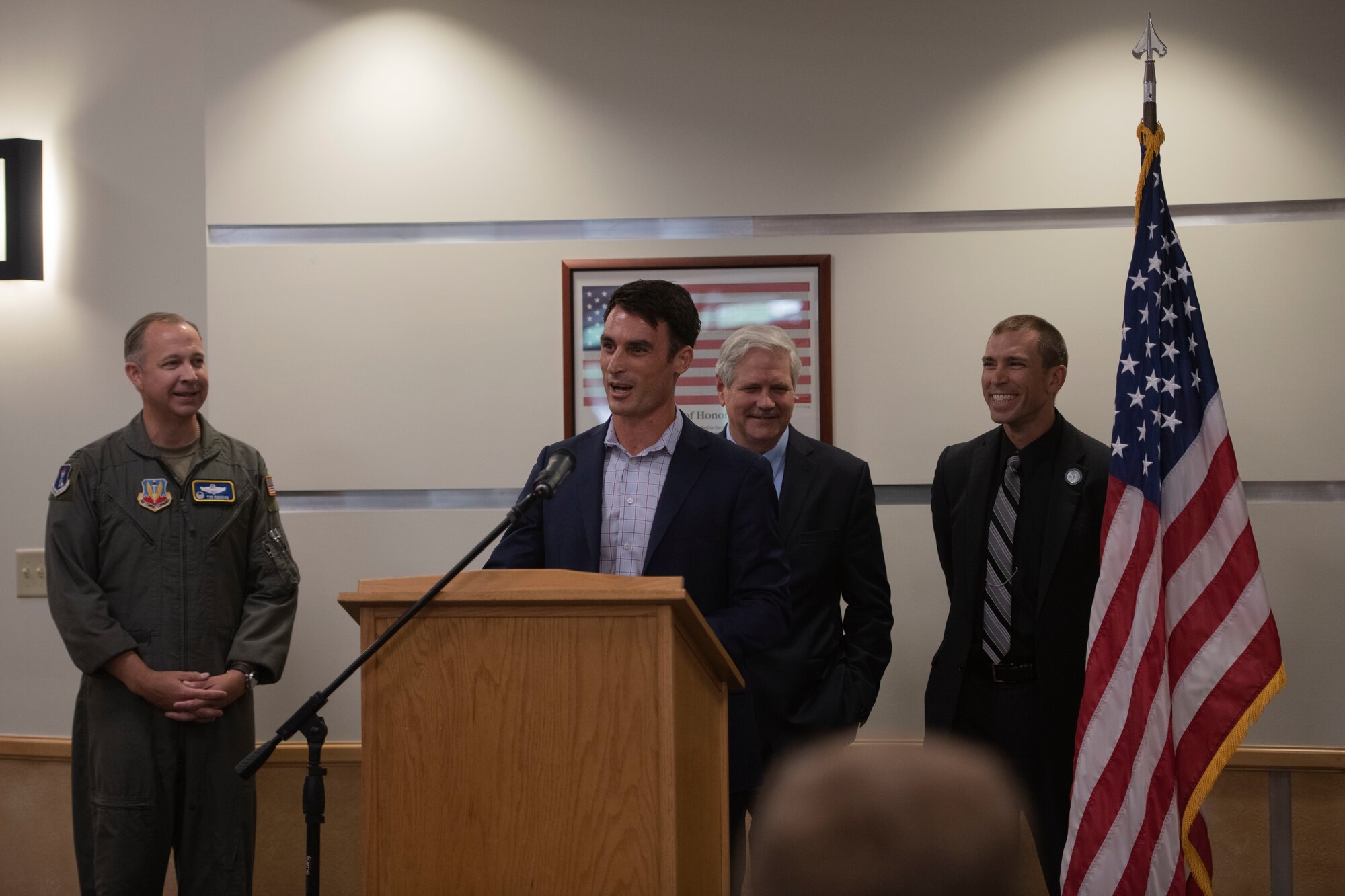 Man speaks behind podium.