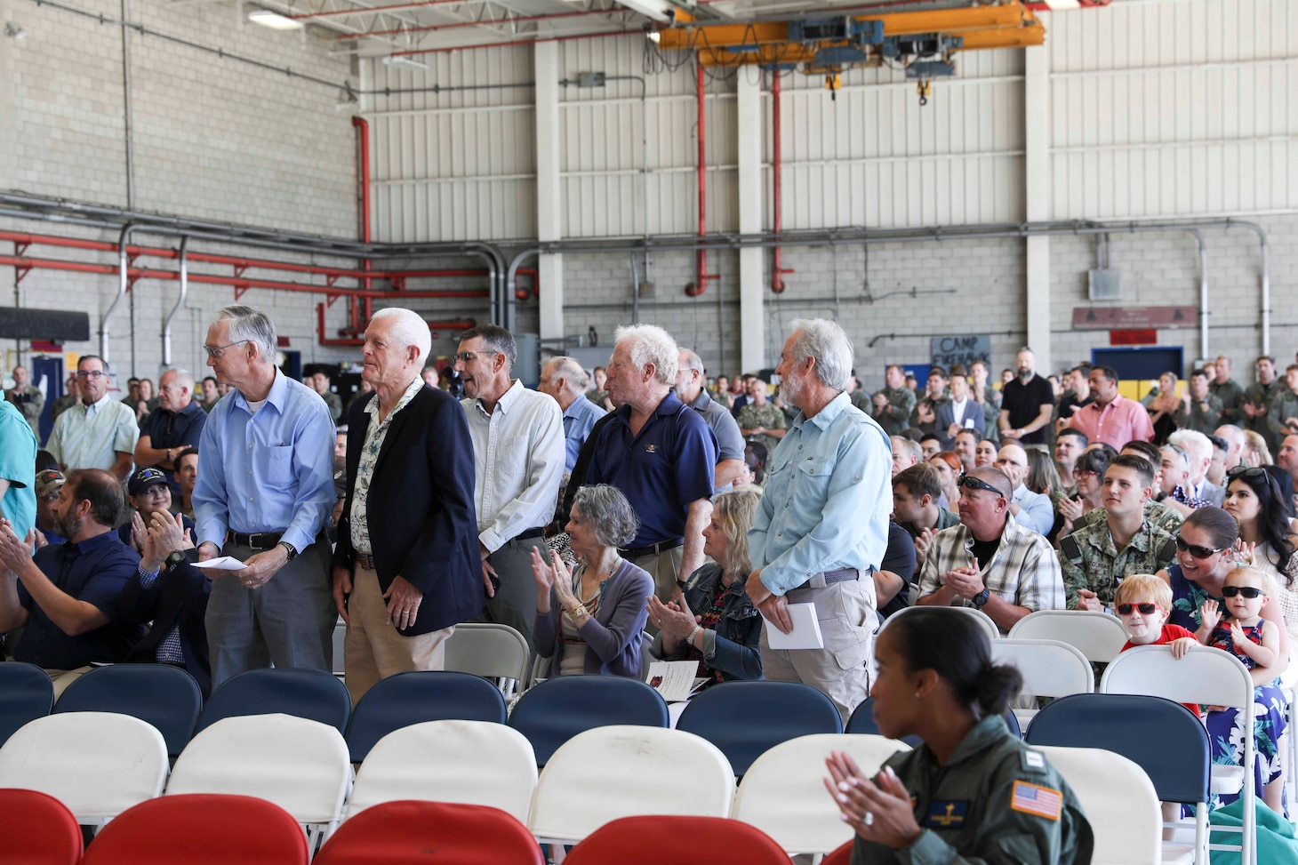 Veterans who served with previously-deactivated squadrons that provided special warfare and/or search and rescue support stand for recognition during the deactivation ceremony of Helicopter Sea Combat Squadron (HSC) 85.