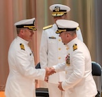 Capt. Nate Schneider, at right, presents the SUPSHIP Gulf Coast command pin to Capt. Randy Slaff, signifying the transfer of authority and responsibility for the command. Looking on is Rear Admiral Tom Anderson, Program Executive Officer for Ships.