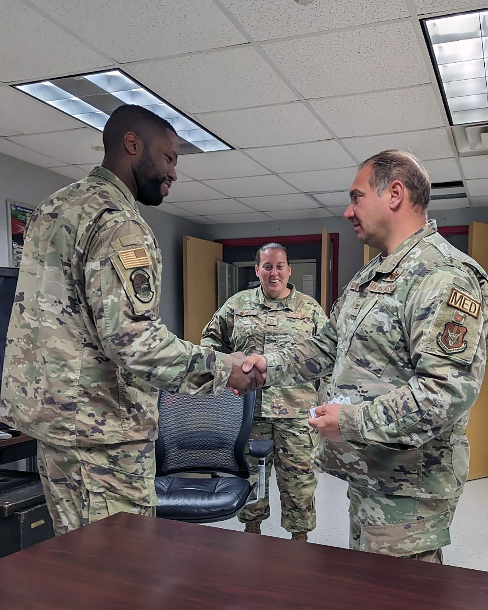 Master Sgt. Jarred Strickland, 55th Combat Communications Squadron, is coined by Col. Joseph Catalino, commander of the 439th Aeromedical Evacuation Squadron at Westover Air Reserve Base, Massachusetts on July 22, 2023. (Courtesy photo)