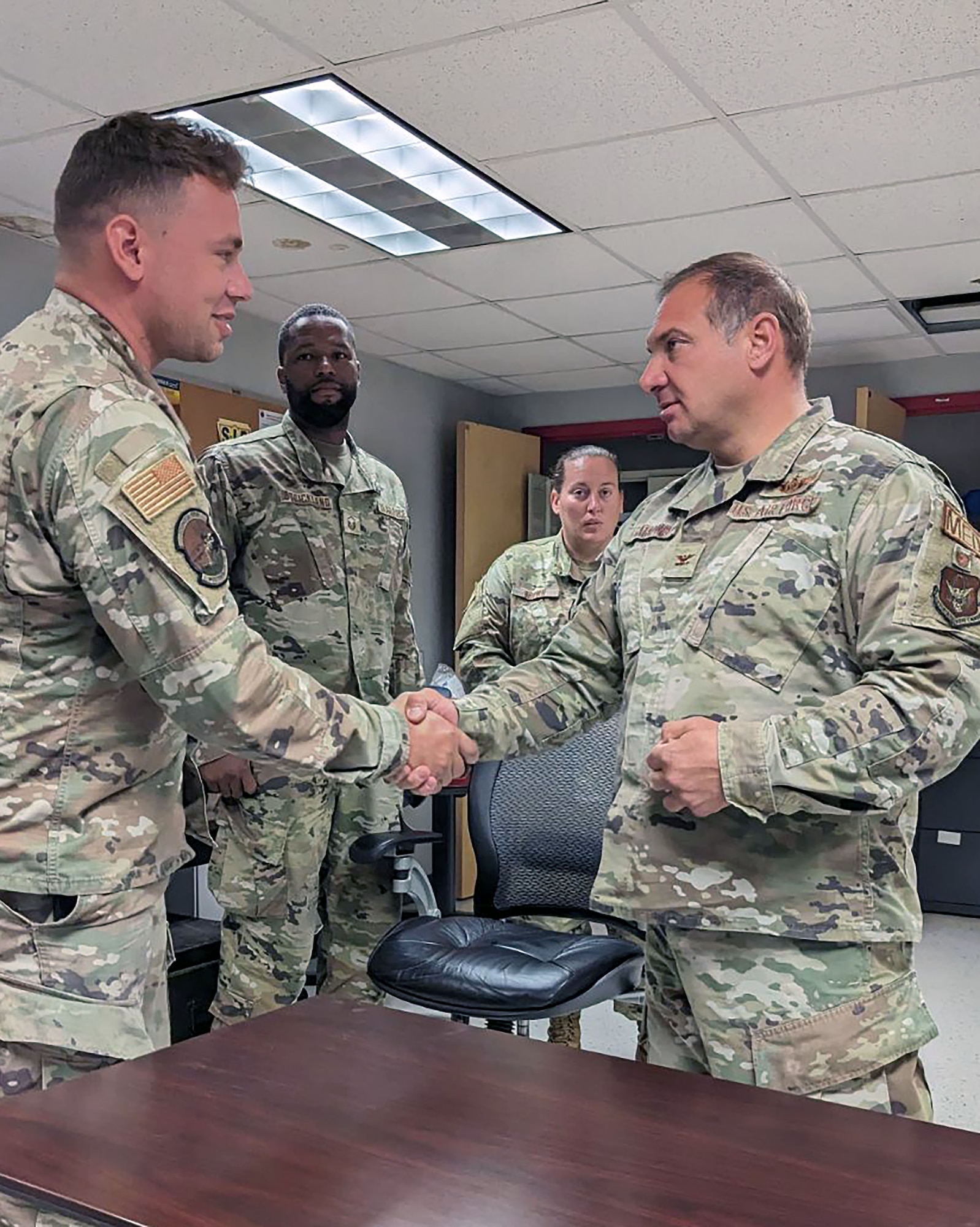 Master Sgt. Shawn Sikes, 55th Combat Communications Squadron, is coined by Col. Joseph Catalino, commander of the 439th Aeromedical Evacuation Squadron at Westover Air Reserve Base, Massachusetts on July 22, 2023. (Courtesy photo)