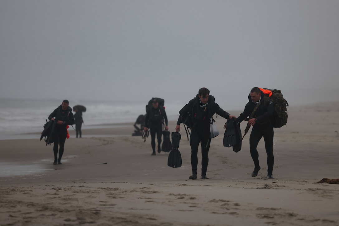 Participants exit the ocean during the 14th Annual Recon Challenge on Marine Corps Base Pendleton, California, April 28, 2023. To honor their fallen comrades and support the Gold Star families through their struggle, reconnaissance Marines and veterans participate in a 25-mile obstacle course throughout Camp Pendleton that tests their physical limits and enhances camaraderie. Each competitor carries a rucksack with a combat load and the name of a fallen Marine or sailor attached to the back. (U.S. Marine Corps photo by Cpl. Angela Wilcox)