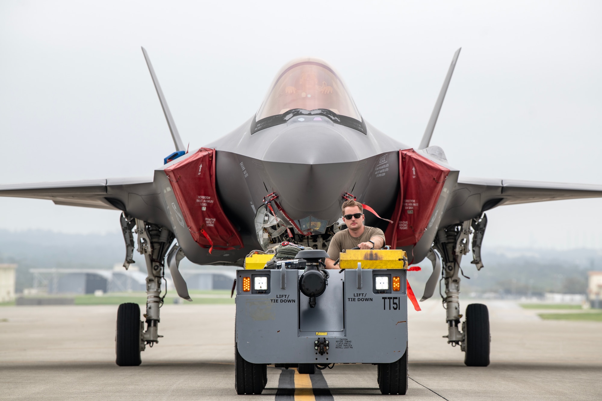 Air Force crew chief assigned to the 354th Aircraft Maintenance Squadron tows an F-35A Lightning II.