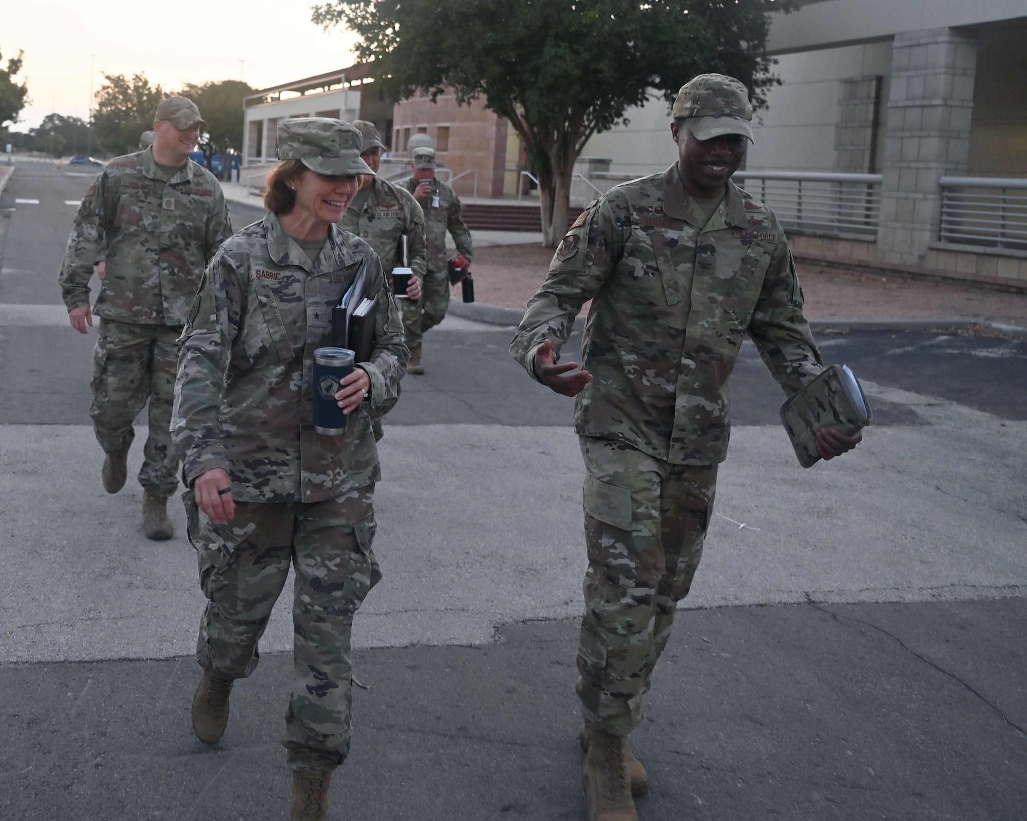 Brig. Gen. Regina Sabric (left), 10th Air Force commander, and Chief Master Sgt. Christopher Bluto (rear), 10th Air Force command chief, proceed to a briefing on the status of Air Force Reserve Command's cyberspace operations at Joint Base San Antonio-Lackland, Texas on August 8, 2023. She is accompanied by Col. Silas Darden (right), 960th Cyberspace Wing commander, and Chief Master Sgt. Christopher Howard (left), 960th Cyberspace Wing command chief. (Air Force photo by 2nd Lt. Alex Dieguez)