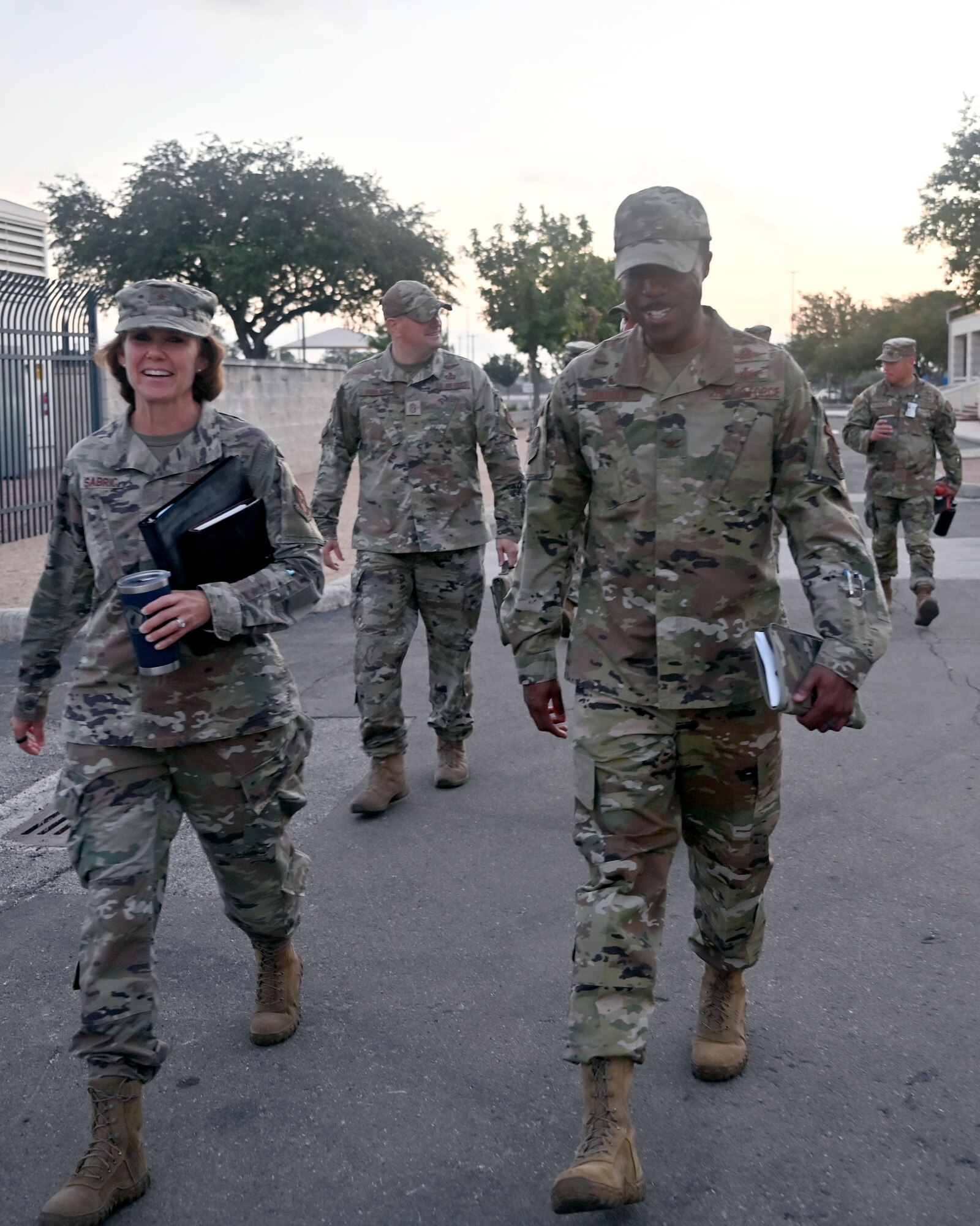 Brig. Gen. Regina Sabric (left), 10th Air Force commander, and Chief Master Sgt. Christopher Bluto, 10th Air Force command chief, proceed to a briefing on the status of Air Force Reserve Command's cyberspace operations at Joint Base San Antonio-Lackland, Texas on August 8, 2023. She is accompanied by Col. Silas Darden (right), 960th Cyberspace Wing commander, and Chief Master Sgt. Christopher Howard (center), 960th Cyberspace Wing command chief. (Air Force photo by 2nd Lt. Alex Dieguez)