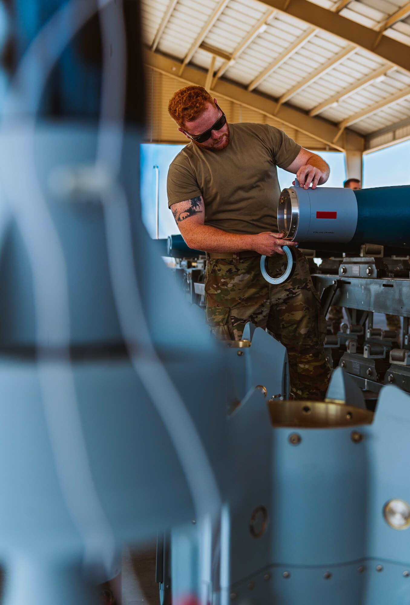 U.S. Air Force Staff Sergeant Michael Clark, 56th Equipment Maintenance Squadron equipment specialist, assembles a GBU-12 Paveway II bomb, training for the Air Force Combat Operation Competition.