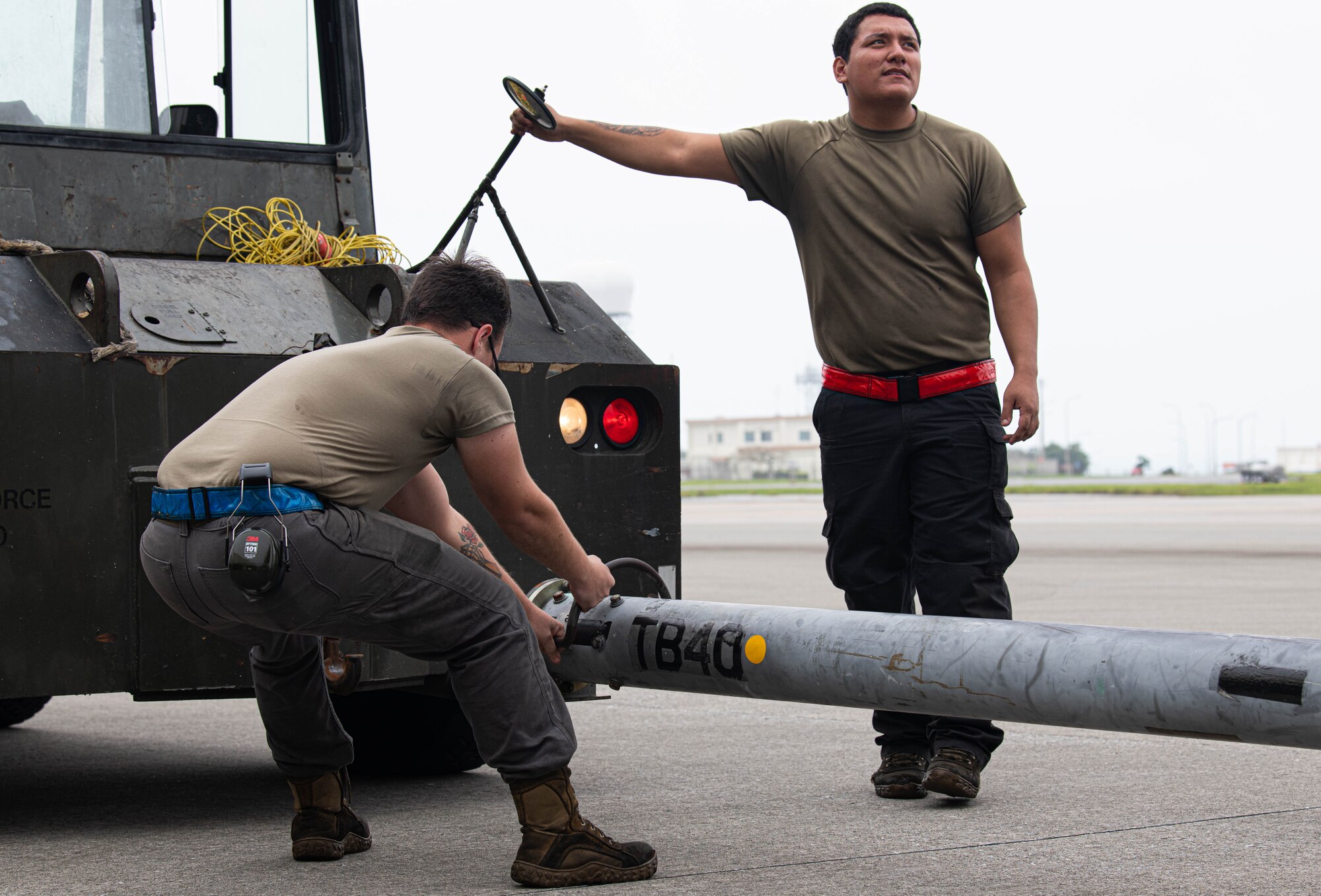 Assistant dedicated crew chiefs assist in towing an F-15C Eagle..
