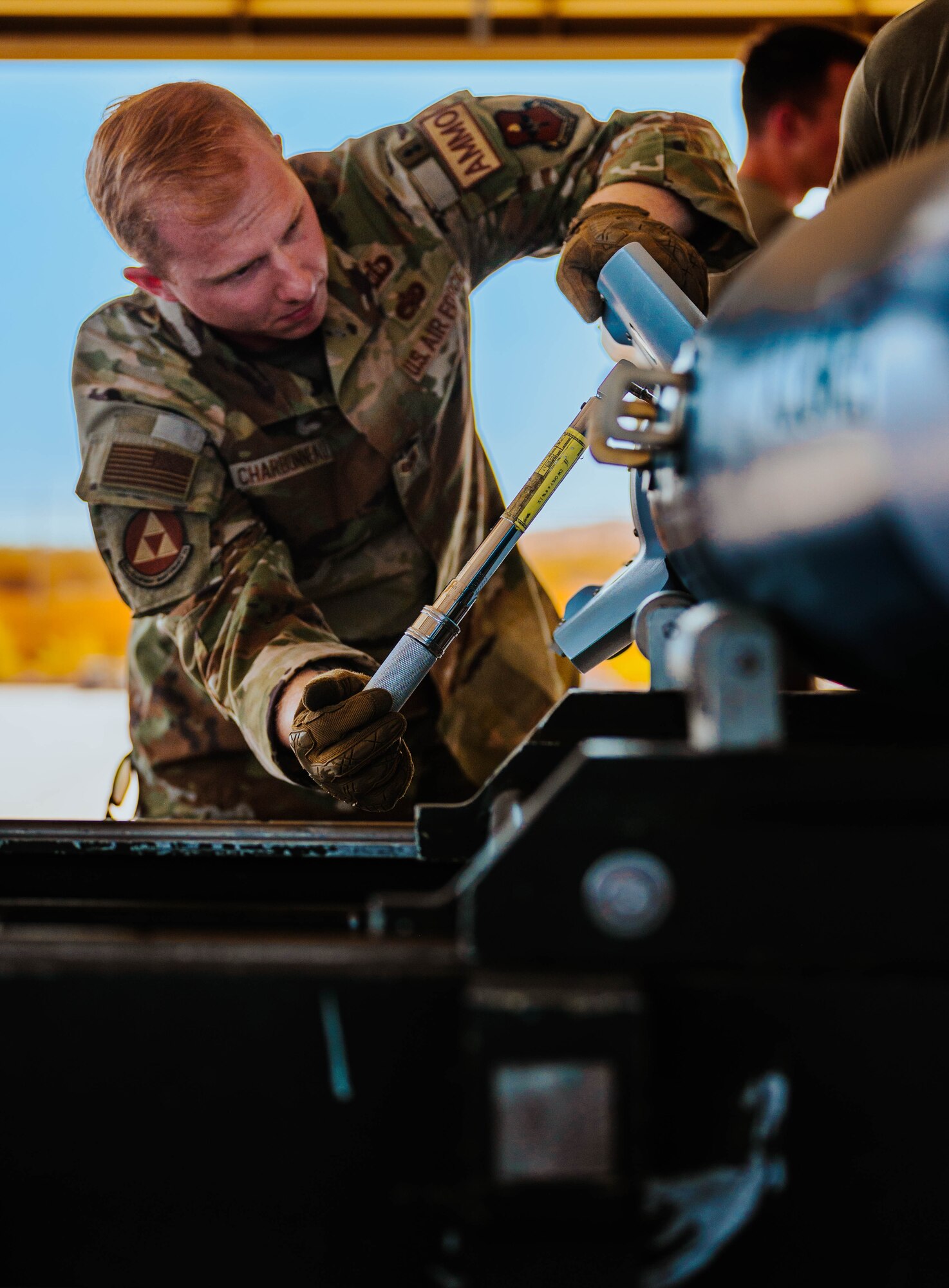 U.S. Air Force Staff Sgt. Tristan Charbonneau, 56th Equipment Maintenance Squadron storage supervisor, assembles a GBU-12 Paveway II bomb, training for the Air Force Combat Operation Competition.