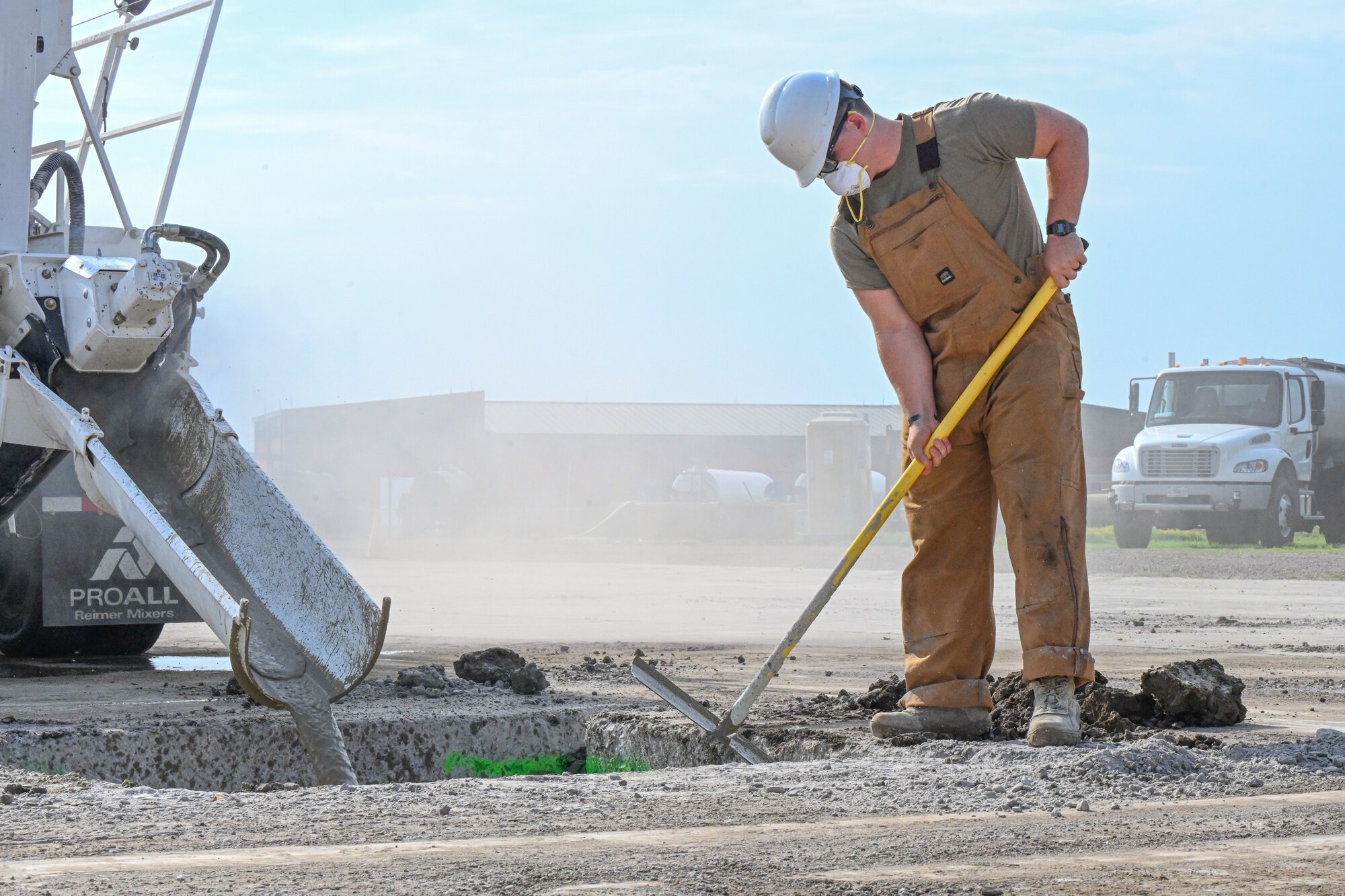 Airman smooths out concrete.