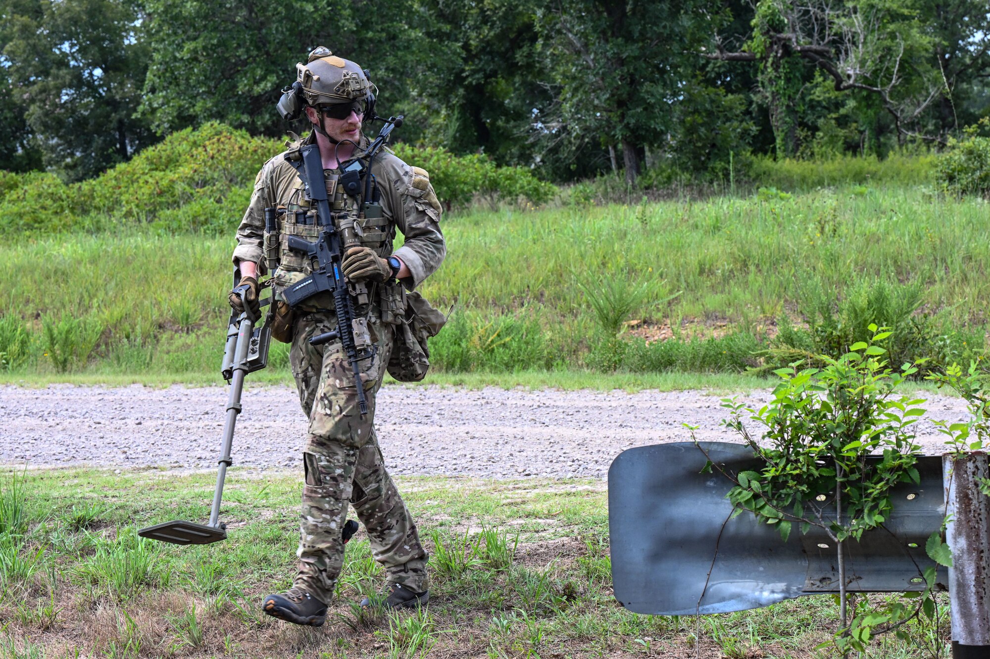 Airmen uses a metal detector.