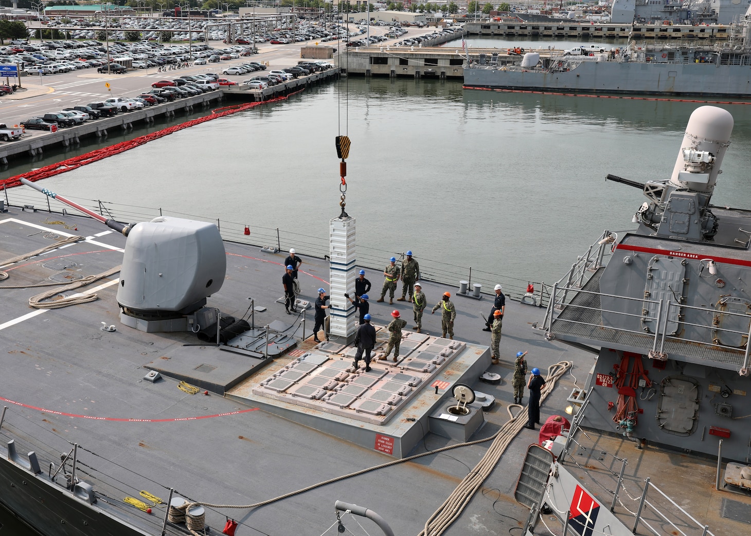 230803-N-OH262-1258 NORFOLK, Va. (August 3, 2023)--Sailors assigned to the Arleigh Burke-class destroyer USS Porter (DDG 78) and Navy Expeditionary Logistics Support Group’s Expeditionary Reload Team stow simulated ordnance in the ship's MK 71 Vertical Launch System (VLS) during a VLS re-arm demonstration held pier-side on Naval Station Norfolk, Aug. 3. The VLS demonstration was part of U.S. Fleet Forces Command's Large Scale Exercise 2023 which provides a venue to test and refine current and new technologies and platforms to reinforce our current position as a supreme maritime force and provide feedback used to inform future innovation. (U.S. Navy photo by Bill Mesta)