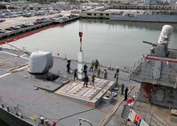 230803-N-OH262-1258 NORFOLK, Va. (August 3, 2023)--Sailors assigned to the Arleigh Burke-class destroyer USS Porter (DDG 78) and Navy Expeditionary Logistics Support Group’s Expeditionary Reload Team stow simulated ordnance in the ship's MK 71 Vertical Launch System (VLS) during a VLS re-arm demonstration held pier-side on Naval Station Norfolk, Aug. 3. The VLS demonstration was part of U.S. Fleet Forces Command's Large Scale Exercise 2023 which provides a venue to test and refine current and new technologies and platforms to reinforce our current position as a supreme maritime force and provide feedback used to inform future innovation. (U.S. Navy photo by Bill Mesta)