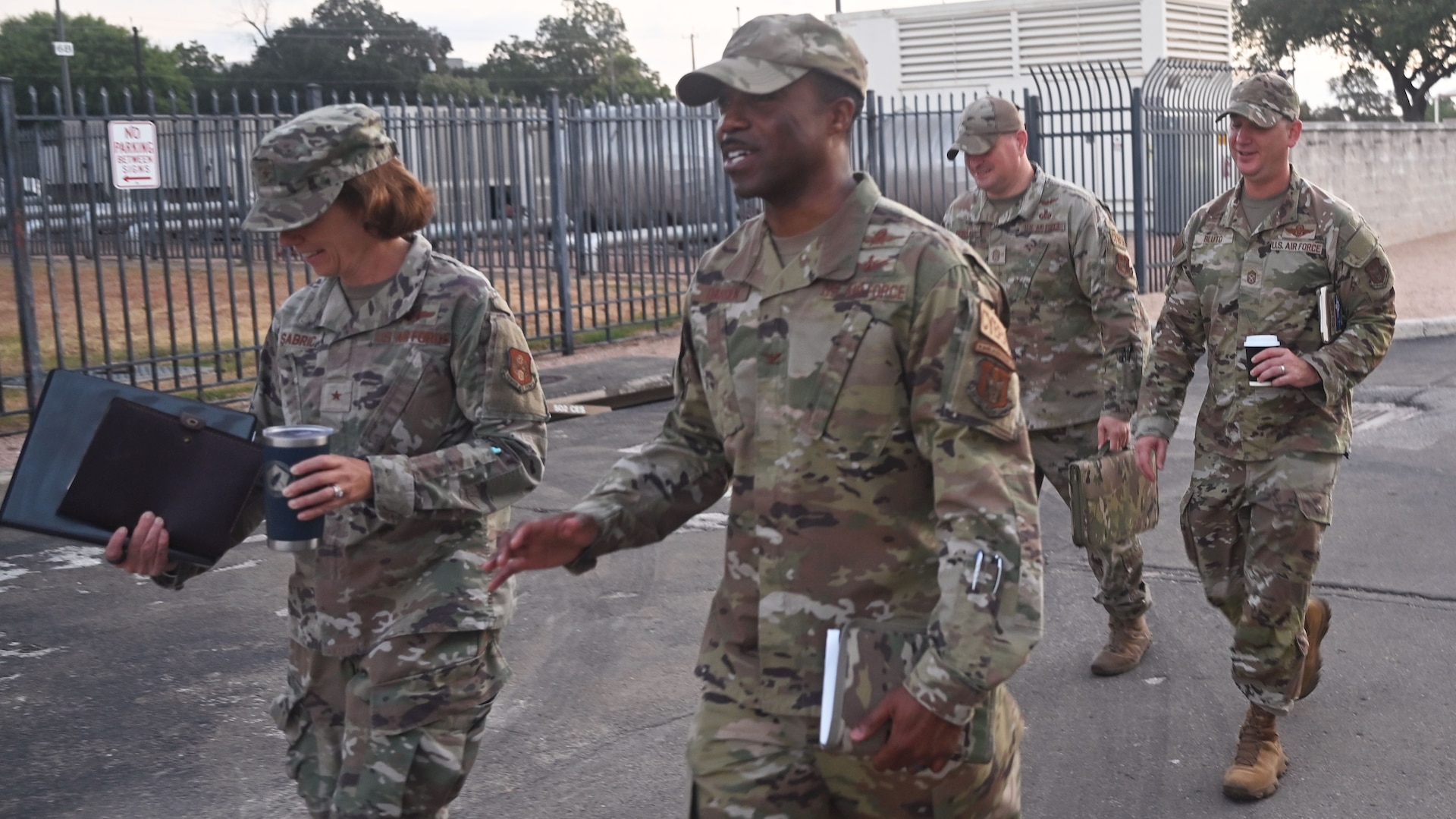 Brig. Gen. Regina Sabric (left), 10th Air Force commander, and Chief Master Sgt. Christopher Bluto (right), 10th Air Force command chief, proceed to a briefing on the status of Air Force Reserve Command's cyberspace operations at Joint Base San Antonio-Lackland, Texas on August 8, 2023. She is accompanied by Col. Silas Darden (center), 960th Cyberspace Wing commander, and Chief Master Sgt. Christopher Howard (center-right), 960th Cyberspace Wing command chief. (Air Force photo by 2nd Lt. Alex Dieguez)