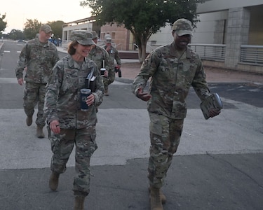 Brig. Gen. Regina Sabric (left), 10th Air Force commander, and Chief Master Sgt. Christopher Bluto (rear), 10th Air Force command chief, proceed to a briefing on the status of Air Force Reserve Command's cyberspace operations at Joint Base San Antonio-Lackland, Texas on August 8, 2023. She is accompanied by Col. Silas Darden (right), 960th Cyberspace Wing commander, and Chief Master Sgt. Christopher Howard (left), 960th Cyberspace Wing command chief. (Air Force photo by 2nd Lt. Alex Dieguez)