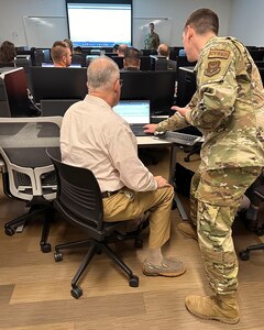 Space Force Technical Sgt. Zachary McCullough, 51st Network Operations Squadron, assists a student with Threat Hunting curriculum at Central New Mexico Community College in Albuquerque, New Mexico on July 20, 2023. (Courtesy photo)