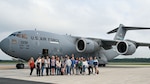 Spouses group photo in front of aircraft