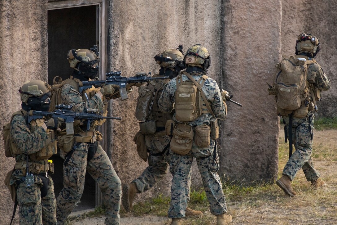U.S. Marines with Advanced Infantry Training Battalion, School of Infantry-West, Hawaii Detachment, prepare to breach a building during urban operations training, Marine Corps Training Area Bellows, July 11, 2023. The training was conducted as part of the Advanced Infantry Marine Course. AIMC is designed to enhance and test Marines’ skills with a focus on reinforcing proper patrols and operational procedures. (U.S. Marine Corps photo by Cpl. Chandler Stacy)