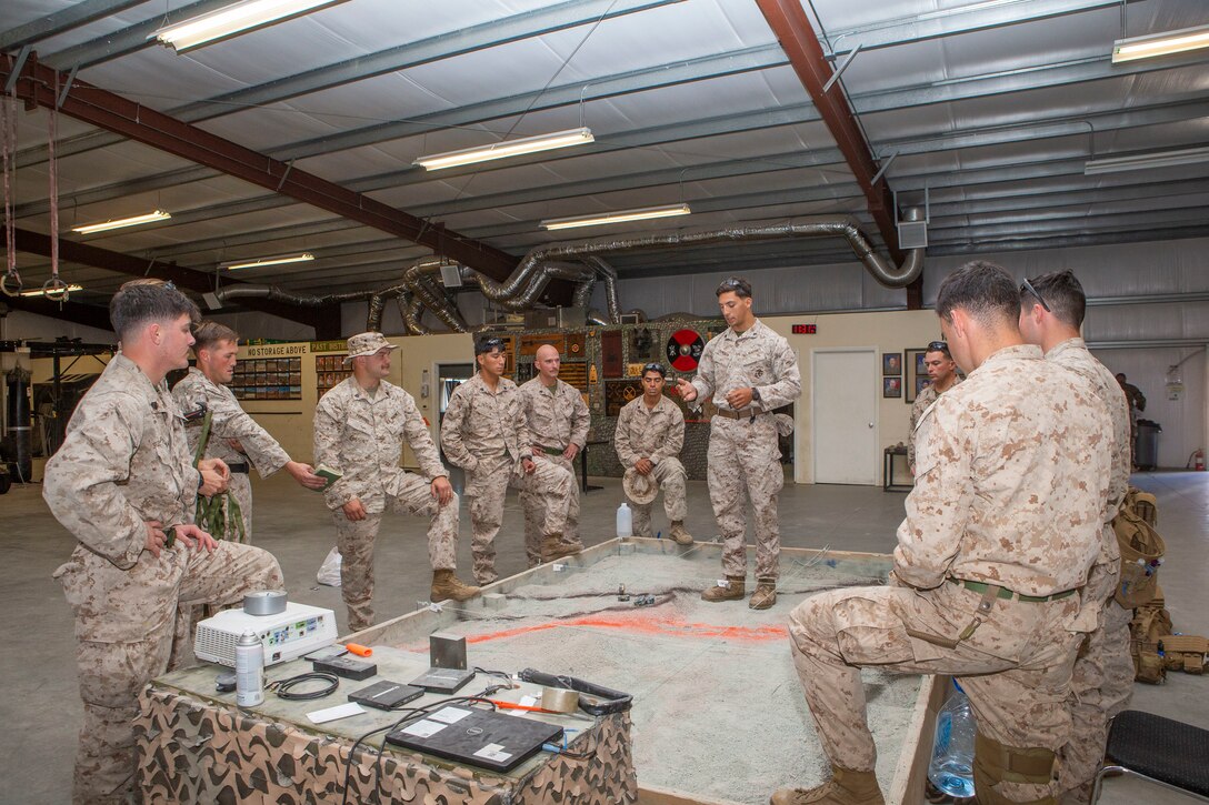 U.S. Marines with the Infantry Small Unit Leaders Course 1-22, Advanced Infantry Training Battalion, School of Infantry - West, brief their patrol before a training exercise on Marine Corps Base Camp Pendleton, California, Nov 16, 2021. The students conducted an aerial assault which took them from SOI-West on Camp Pendleton to Yuma, Arizona. ISULC is designed to teach noncommisioned officers advanced infantry skills and equip them to assume more leadership responsibility within an infantry battalion. (U.S Marine Corps photo by Cpl. Drake Nickels)