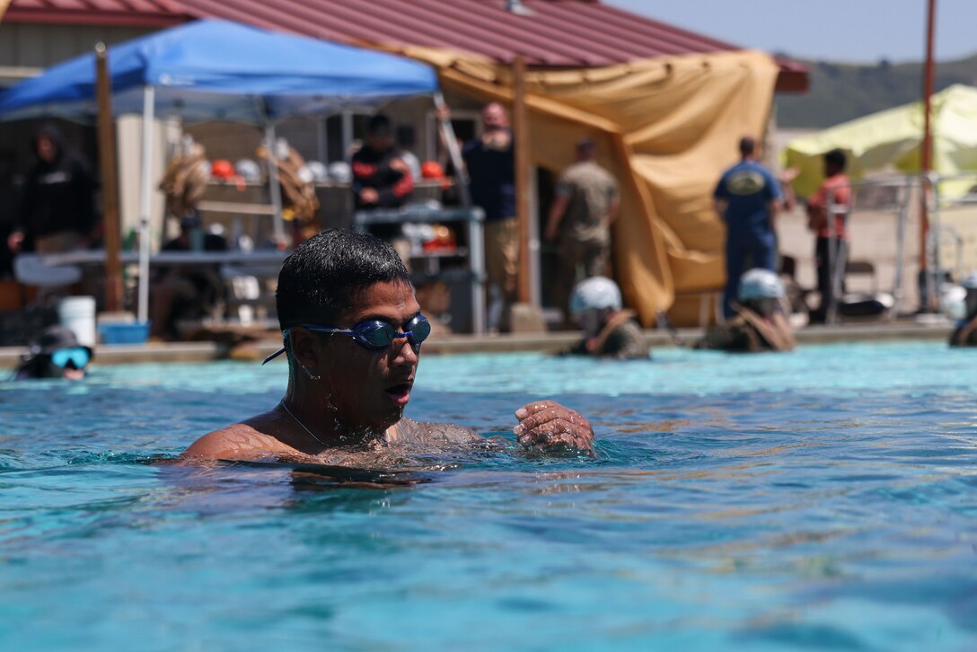 U.S. Marine Corps Staff Sgt. Victor Rangel, a safety swimmer with the Reconnaissance Leader Course, Reconnaissance Training Company, School of Infantry West, evaluates a weapon disassembly/assembly event during the 14th Annual Recon Challenge on Marine Corps Base Pendleton, California, April 28, 2023. To honor their fallen comrades and support the Gold Star families through their struggle, reconnaissance Marines and veterans participate in a 25-mile obstacle course throughout Camp Pendleton that tests their physical limits and enhances camaraderie. Each competitor carries a rucksack with a combat load and the name of a fallen Marine or sailor attached to the back. (U.S. Marine Corps photo by Cpl. Angela Wilcox)