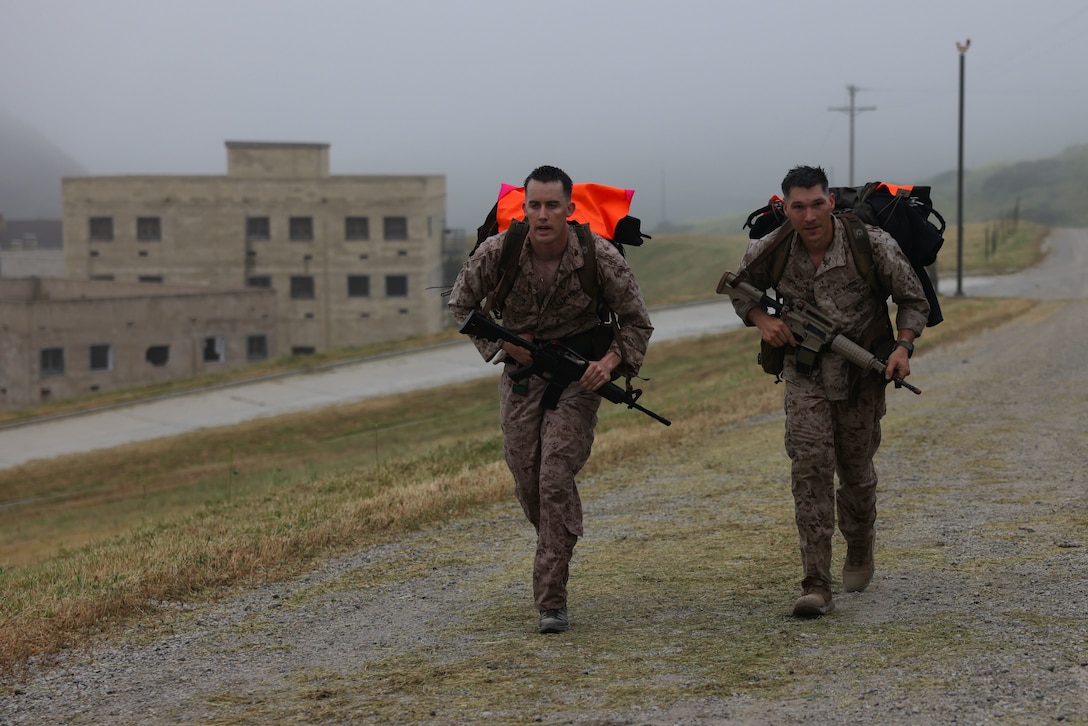 A team of participants hikes during the 14th Annual Recon Challenge on Marine Corps Base Pendleton, California, April 28, 2023. To honor their fallen comrades and support the Gold Star families through their struggle, reconnaissance Marines and veterans participate in a 25-mile obstacle course throughout Camp Pendleton that tests their physical limits and enhances camaraderie. Each competitor carries a rucksack with a combat load and the name of a fallen Marine or sailor attached to the back. (U.S. Marine Corps photo by Cpl. Angela Wilcox)