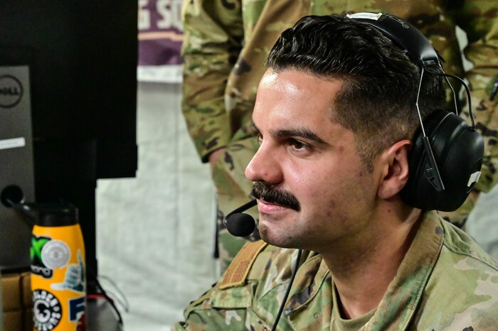 side profile of man sitting  in front of a computer