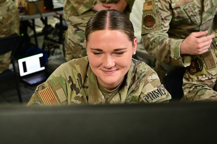 women sitting behind computer