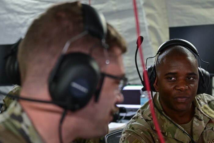 man looking at another man in uniform
