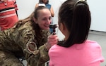 Alaska Air National Guard Lt. Col. Elizabeth Lafleur, 176th Medical Group, examines a patient July 14, 2023, as part of an Innovative Readiness Training mission at Saipan, Commonwealth of Northern Mariana Islands. IRTs bring experienced Air National Guard and Army Reserve medical professionals to a real-world environment, allowing them to hone their skills while helping the community.