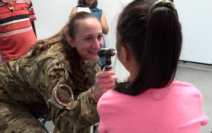 Alaska Air National Guard Lt. Col. Elizabeth Lafleur, 176th Medical Group, examines a patient July 14, 2023, as part of an Innovative Readiness Training mission at Saipan, Commonwealth of Northern Mariana Islands. IRTs bring experienced Air National Guard and Army Reserve medical professionals to a real-world environment, allowing them to hone their skills while helping the community.