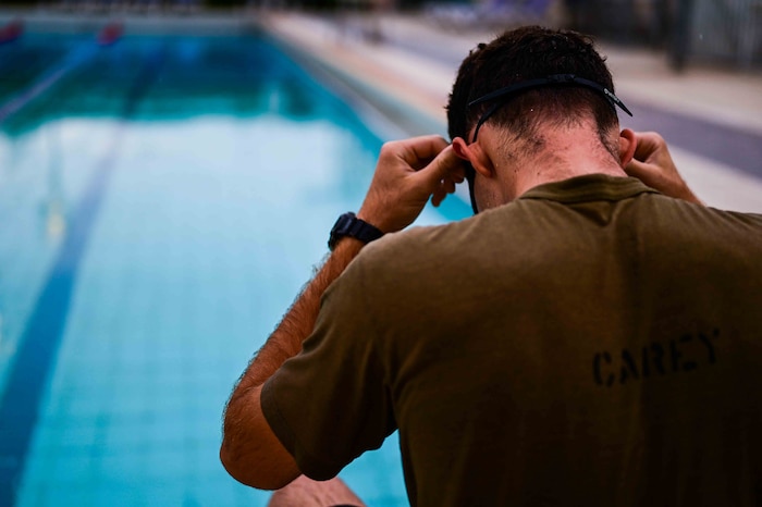 U.S. Air Force Senior Airman Sean Carey, 31st Maintenance group aerospace ground equipment journeyman, adjusts his goggles before starting his swim intervals.