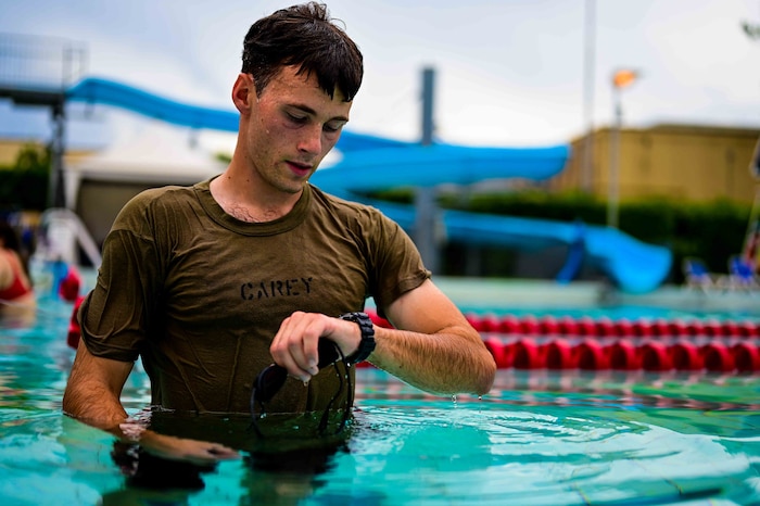 U.S. Air Force Senior Airman Sean Carey, 31st Maintenance group aerospace ground equipment journeyman, checks his stopwatch after completing his swim intervals.