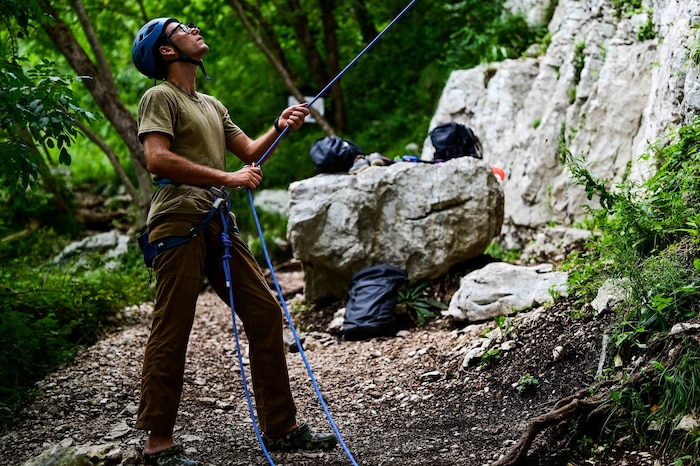 U.S. Air Force Senior Airman Sean Carey, 31st Maintenance group aerospace ground equipment journeyman, belays his rock-climbing partner at a rock-climbing wall.