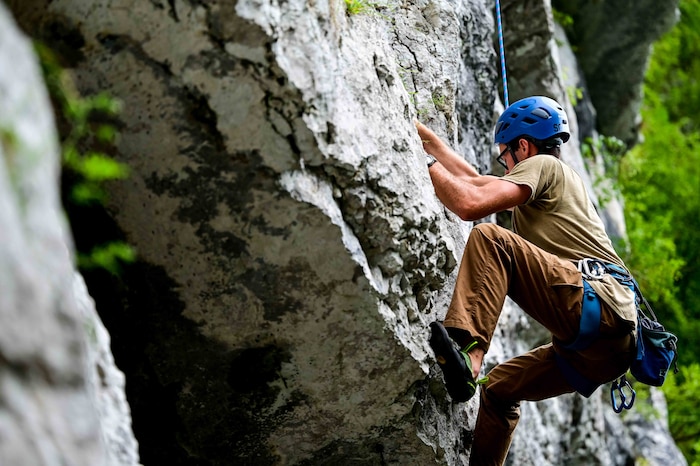 U.S. Air Force Senior Airman Sean Carey, 31st Maintenance group aerospace ground equipment journeyman, ascends a medium difficulty wall while rock-climbing.