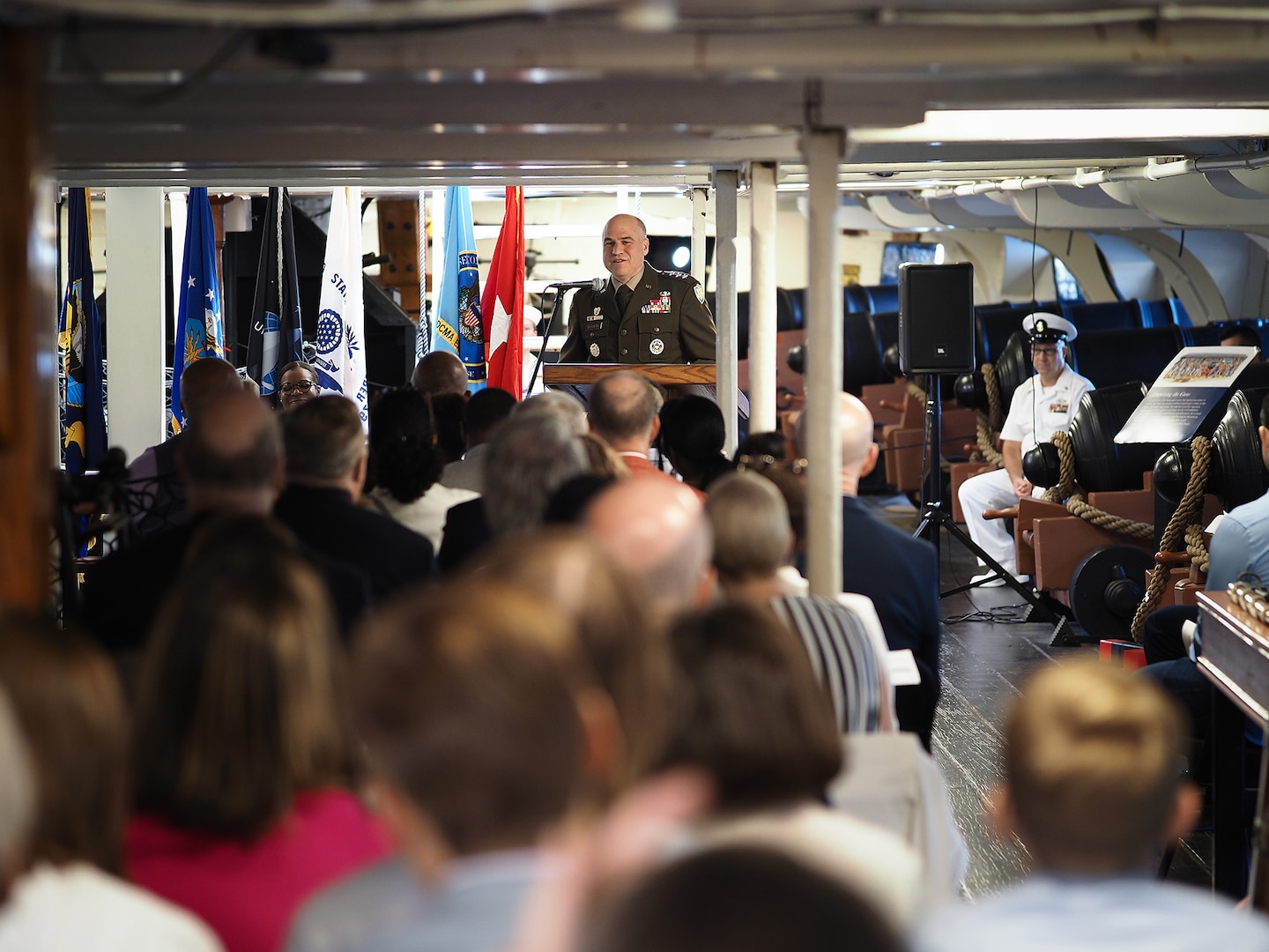 An Army officer in speaks from a podium