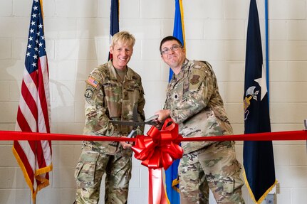 U.S. Army Brig. Gen. Laura L. Clellan, the adjutant general of the Colorado National Guard, cuts a ribbon with U.S. Air Force Lt. Col. Andy Gold, commander of the 138th Electronic Warfare Squadron, to mark the opening of its new facility on Peterson Space Force Base, Colorado Springs, Colo., Aug. 5, 2023.