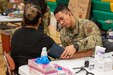 Airman Matthew Cai, 146th Airlift Wing medic, checks a patient's blood pressure during Innovative Readiness Training's Healthy Tennesseans event at Rhea Middle School, Dayton, Tenn., June 3, 2023. The IRT program provides an array of services to communities in need including civil engineering, medical, and cybersecurity missions while also serving the service members who volunteer for the missions by providing real-world training opportunity to enhance readiness. (U.S. Air Force photo by Tech. Sgt. Kristen Pittman)