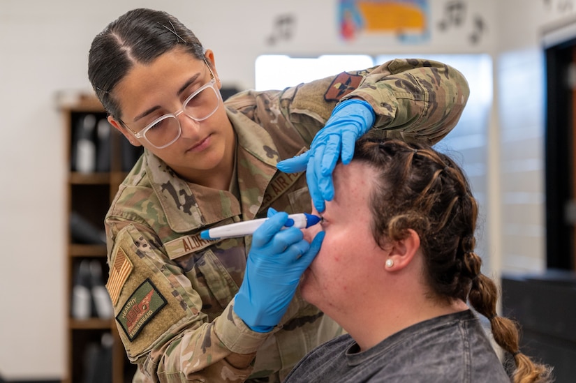 Airman 1st Class Peyten Aldrich, 81st Medical Group opthamology technician, checks the pressure of a patient's eye during Innovative Readiness Training's Healthy Tennesseans event at Bledsoe County High School in Pikeville, Tenn., June 4, 2023. The IRT program provides an array of services to communities in need including civil engineering, medical, and cybersecurity missions while also serving the service members who volunteer for the missions by providing real-world training opportunity to enhance readiness.(U.S. Air Force photo by Tech. Sgt. Kristen Pittman)