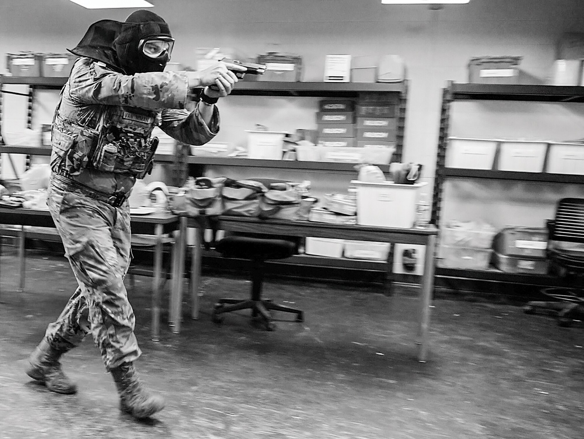 U.S. Air Force Master Sgt. Justin Van Nima, 445th Security Force Squadron Training and Readiness noncommissioned officer in charge, moves to clear a room during active shooter training at Calamityville, Fairborn, Ohio, July 14, 2023. Airmen with the 445th Airlift Wing, alongside civilian law enforcement, learned how to properly respond to active shooter scenes during the training that is held once a year, as well as critical care. (U.S. Air Force photo by Amanda Dick)