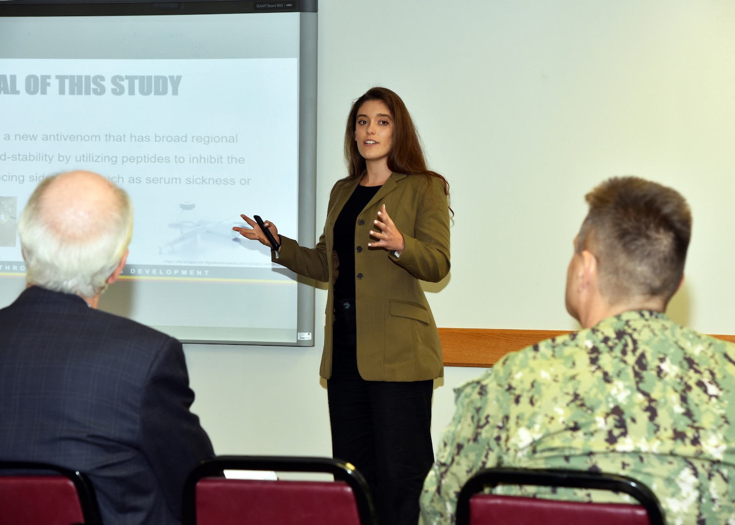 JOINT BASE SAN ANTONO-FORT SAM HOUSTON – (Aug. 2, 2023) – Arizona State University graduate Gabriella Alessio, of Scottsdale, Ariz., an intern assigned to Naval Medical Research Unit (NAMRU) San Antonio, delivers her briefing titled “Using Phage Display to Detect Evenomation and Inhibit Venom Activities” to her mentor, Dr. Daniel Arens, NAMRU San Antonio leadership and other researchers as part of the Office of Naval Research’s Naval Research Enterprise Internship Program (NREIP) at the Battlefield Health and Trauma Research Institute. NREIP places college and university students in the Department of the Navy laboratories where they take part in real Naval research for ten weeks during the summer. NREIP gives academically talented college students, graduating seniors, and graduate students pursuing STEM careers the opportunity to learn about Naval research and technology while receiving first-class mentoring by top scientists and engineers. NAMRU San Antonio is one of the leading research and development laboratories for the U.S. Navy under the Department of Defense (DoD) and is one of eight subordinate research commands in the global network of laboratories operating under the Naval Medical Research Command in Silver Spring, Md.  Its mission is to conduct gap driven combat casualty care, craniofacial, and directed energy research to improve survival, operational readiness, and safety of DoD personnel engaged in routine and expeditionary operations. (U.S. Navy photos by Burrell Parmer, NAMRU San Antonio Public Affairs/Released)
