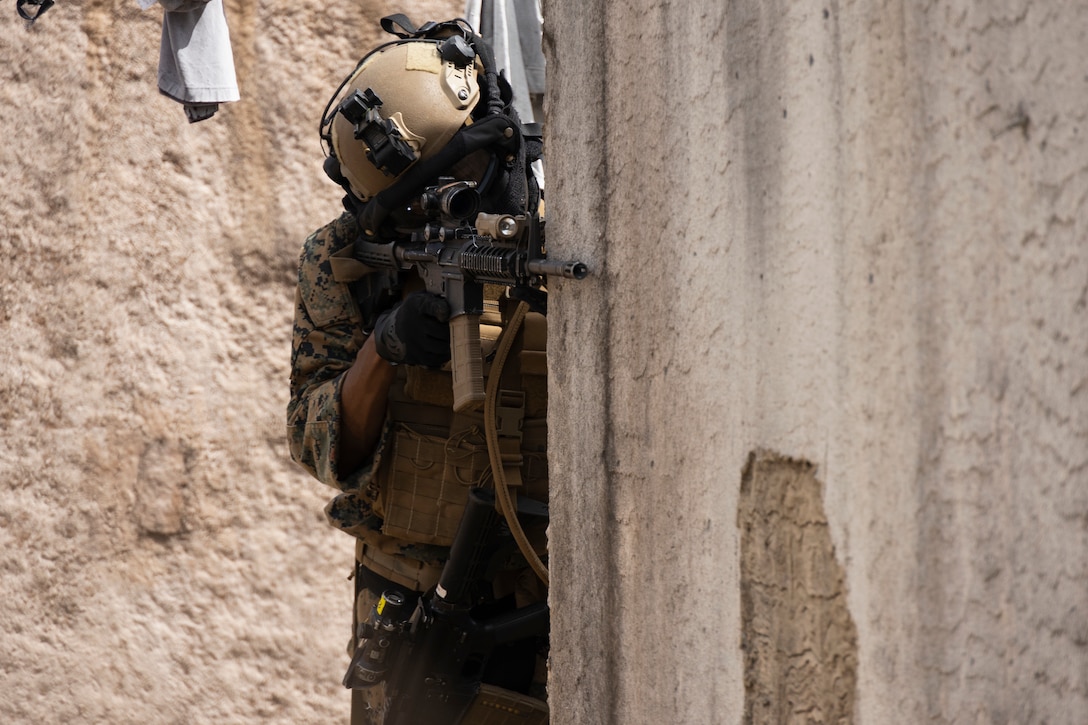 A U.S. Marine with Advanced Infantry Training Battalion, School of Infantry-West, Hawaii Detachment, engages simulated enemy combatants during urban operations training, Marine Corps Training Area Bellows, July 11, 2023. The training was conducted as part of the Advanced Infantry Marine Course. AIMC is designed to enhance and test Marines’ skills with a focus on reinforcing proper patrols and operational procedures. (U.S. Marine Corps photo by Cpl. Chandler Stacy)