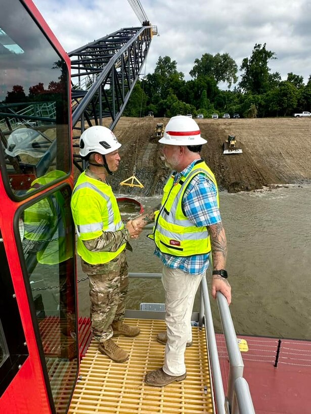 Memphis District Commander Col. Brian Sawser and several members of the district leadership team traveled to Mhoon Bend, Mississippi, on July 12, to visit the district's Bank Grading Unit team and observe the new bank grader, Grader 1, in action for the first time since its arrival and christening earlier this year. 

During his visit, Col. Brian Sawser also presented Crane Operator Ray Boice (pictured left) with a Commander’s Coin in appreciation of his exceptional performance while working with the Memphis District Bank Grading Unit. 

With this year’s revetment season now in full swing, the BGU is laser-focused on accomplishing two key objectives, with the first being training, both contractor-led and on-the-job, to attain the necessary certifications and practice according to each employees' role. 

Additionally, unit operators will use this first test site to calibrate the newly constructed machine, ensuring it's “put through the paces,” so to speak.

Additionally, unit operators will use this first test site to calibrate the newly constructed machine, ensuring it's “put through the paces,” so to speak.