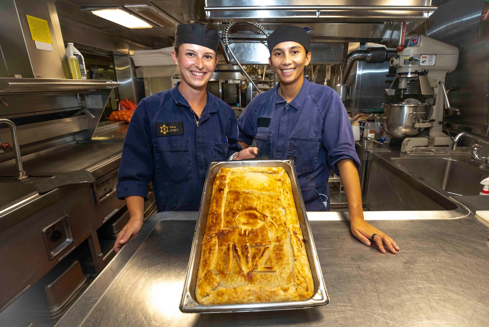 Lead Able Chef Monique Manuel and Able Chef Alice Wyatt, Royal New Zealand Navy Sailors, prepare food aboard U.S. Coast Guard Cutter Stratton (WMSL 752) May 26, 2023, in the South China Sea.  Stratton deployed to the Western Pacific to conduct engagements with regional allies and partner nations, reinforcing a rules-based order in the maritime domain.  (U.S. Navy photo by Chief Petty Officer Brett Cote)