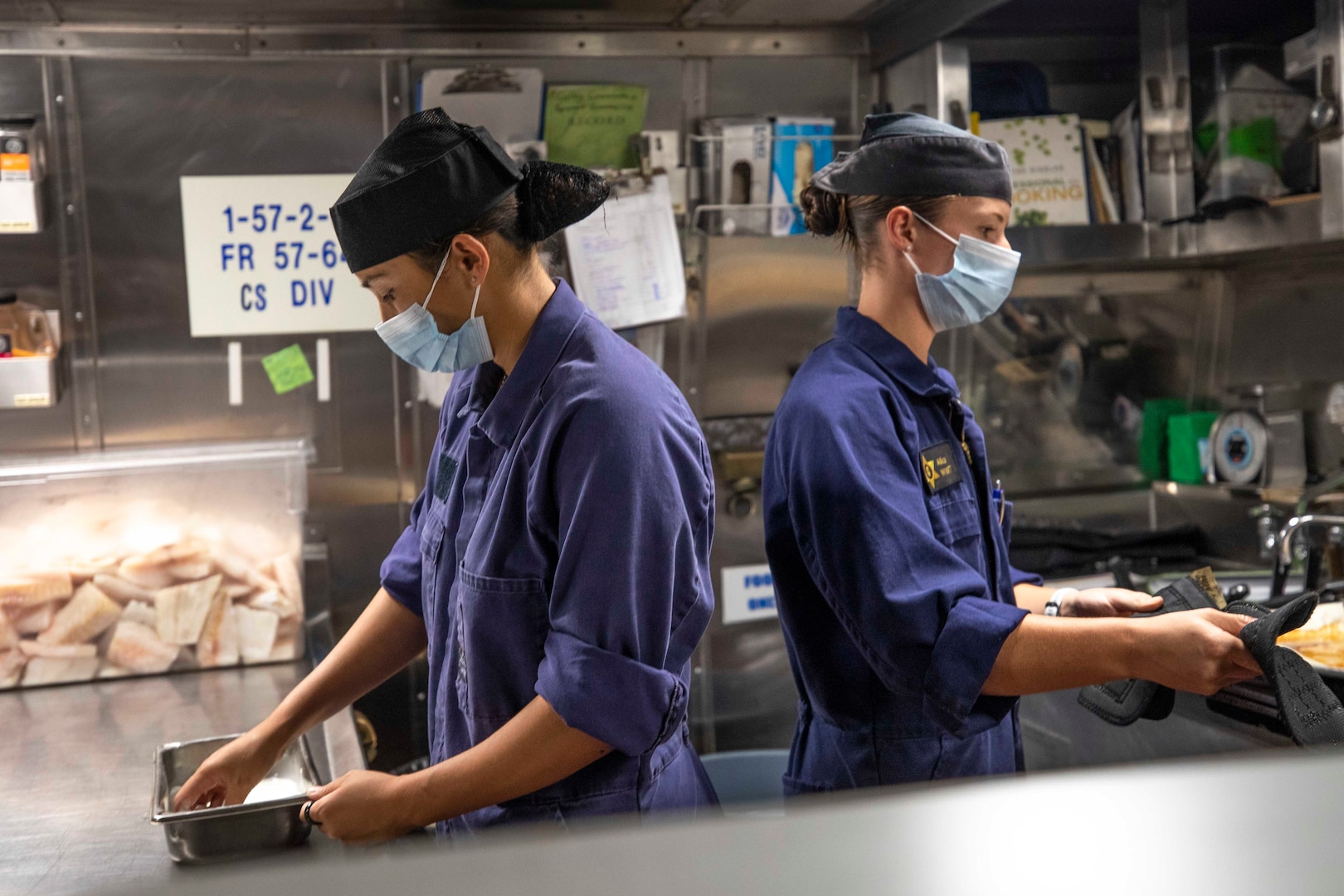 Lead Able Chef Monique Manuel and Able Chef Alice Wyatt, Royal New Zealand Navy Sailors, prepare food aboard U.S. Coast Guard Cutter Stratton (WMSL 752) May 26, 2023, in the South China Sea.  Stratton deployed to the Western Pacific to conduct engagements with regional allies and partner nations, reinforcing a rules-based order in the maritime domain.  (U.S. Navy photo by Chief Petty Officer Brett Cote)